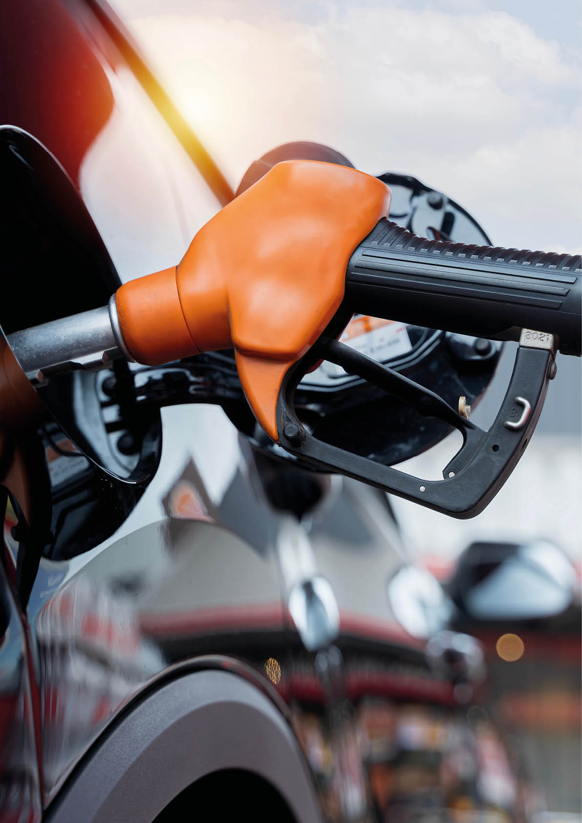 A gas pump is attached to a car. Description generated by AI