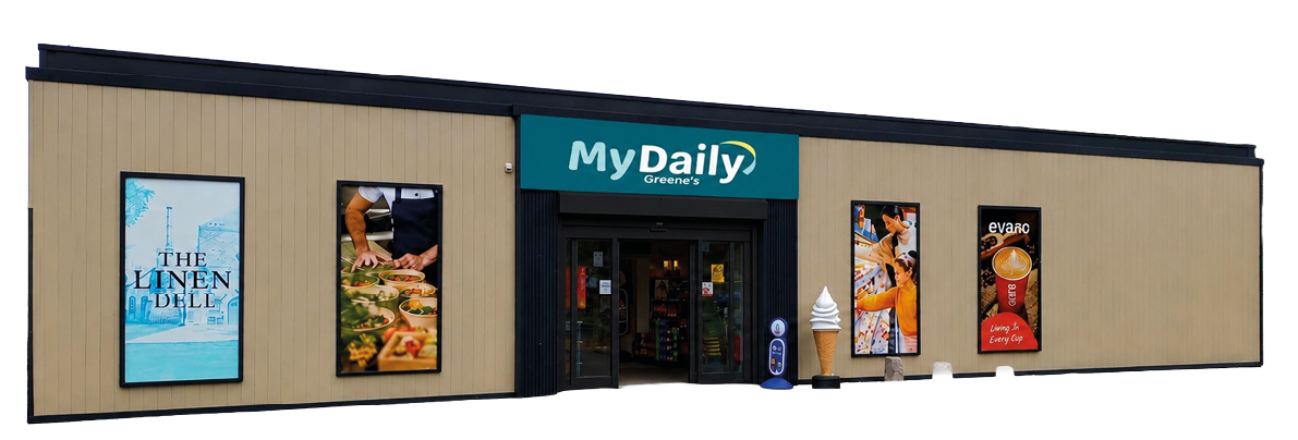 A single-story grocery store building with a sign reading MyDaily Grocers above the entrance and colorful food and product advertisements on the exterior walls. Description generated by AI