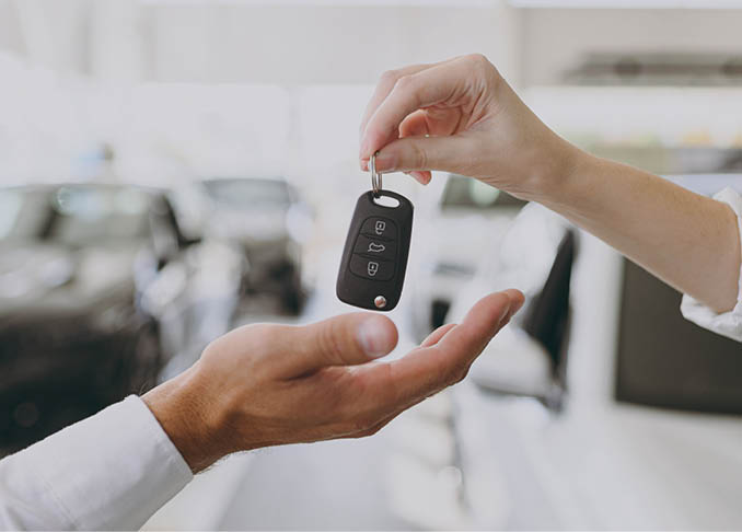 Cropped photo of male customer buyer client receive car keys fob keyless system from salesman choose auto want buy new automobile in showroom vehicle salon dealership store motor show. Sales concept