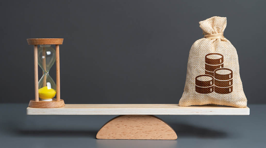 Hourglass and coins money bag on scales . Investing money can save you time. Fulfilling life and financial security. Hourly wages. Find balance to get the most out of each.