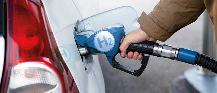 A man fuels a car with hydrogen. Clean transportation concept