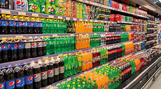 Dubai,united arab emirates- February 02,2024 :Various carbonated soft drinks kept for sale at a hypermarket shelf