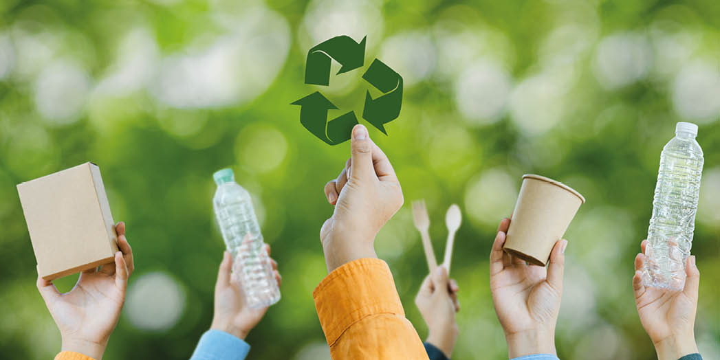 Ecology concept. recycling concept Recycle, plastic free, on a forest nature green background copy space plastic recycling Environmental. Many hands with different types of garbage.