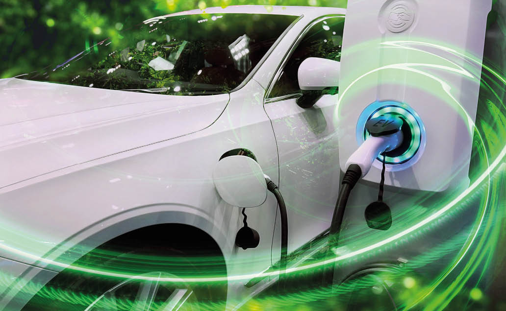 EV Car or Electric vehicle at charging station with the power cable supply plugged in on blurred nature with green enegy power effect. Eco-friendly sustainable energy concept.