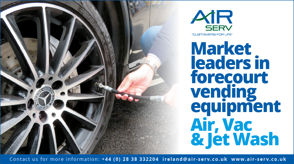 A man is putting air in a tire, while a sign advertises Air, Vac & Jet Wash. AI generated content