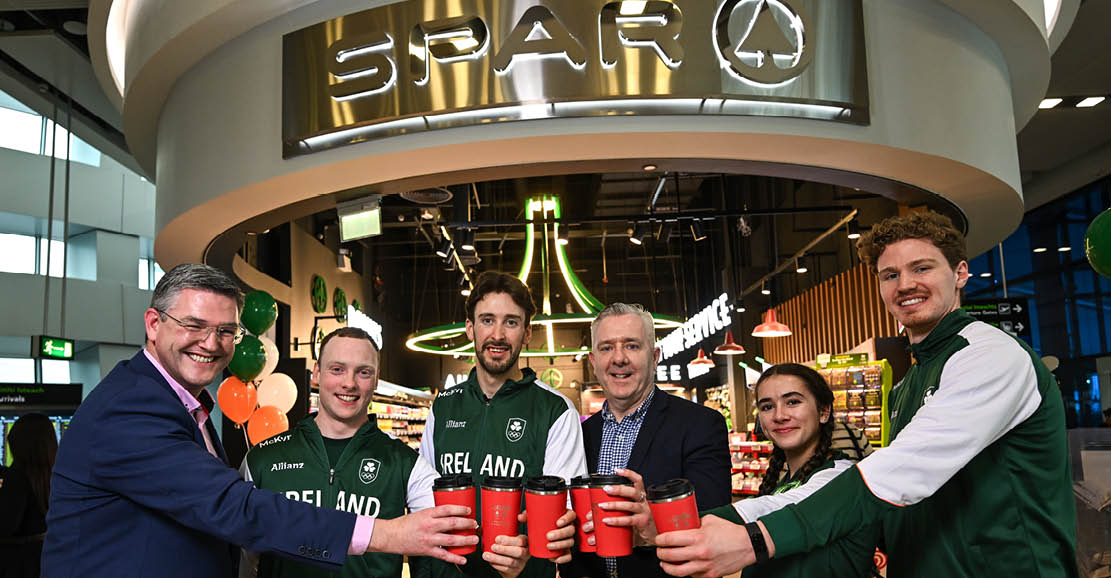 A group of people are holding red cups and posing for a picture in front of a store. AI generated content