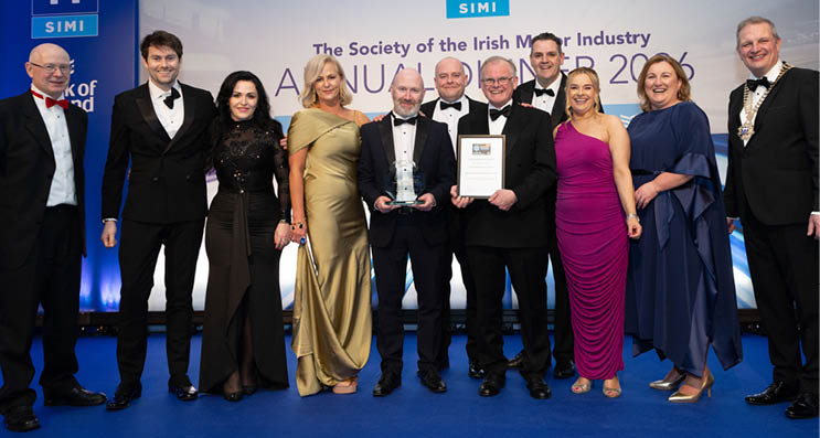 A group of people are posing for a photo, with a man holding an award. AI generated content