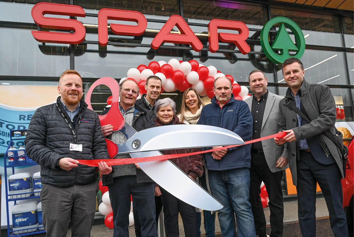 A group of people are standing in front of a store, holding a pair of scissors and a large red ribbon. They are posing for a photo, possibly to celebrate the opening of a new store or a special event. AI generated content