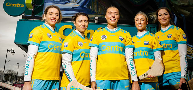 Five women wearing yellow and blue sports uniforms are standing together, holding their sports equipment. AI generated content