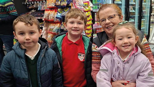 A woman and two children pose for a picture in a store. AI generated content