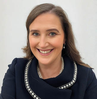 A woman wearing a black jacket and a white and black necklace is smiling. AI generated content