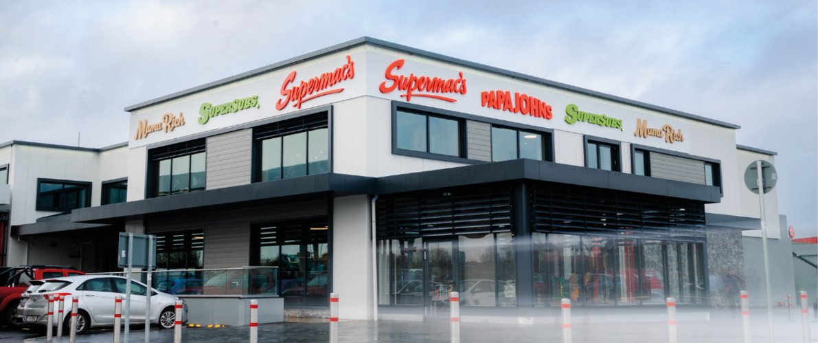 A large white building with a red sign that says “The Banner Plaza." AI generated content