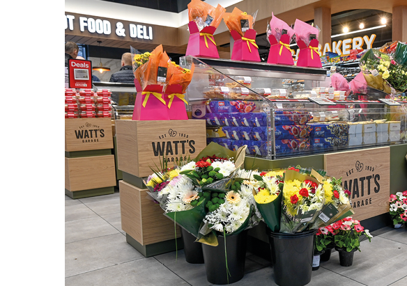 A flower shop with a variety of flowers and pink bags. AI generated content