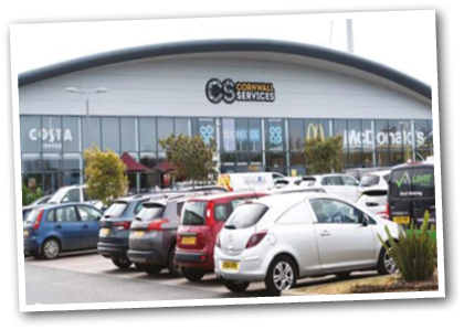 A parking lot outside a building with many cars parked in it. AI generated content