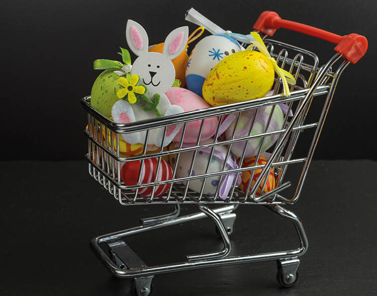 A toy shopping cart filled with stuffed animals and eggs. Description generated by AI