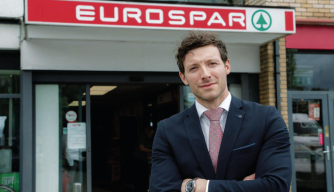 A man in a suit stands in front of a store with a red sign that says “EuroSpar." AI generated content