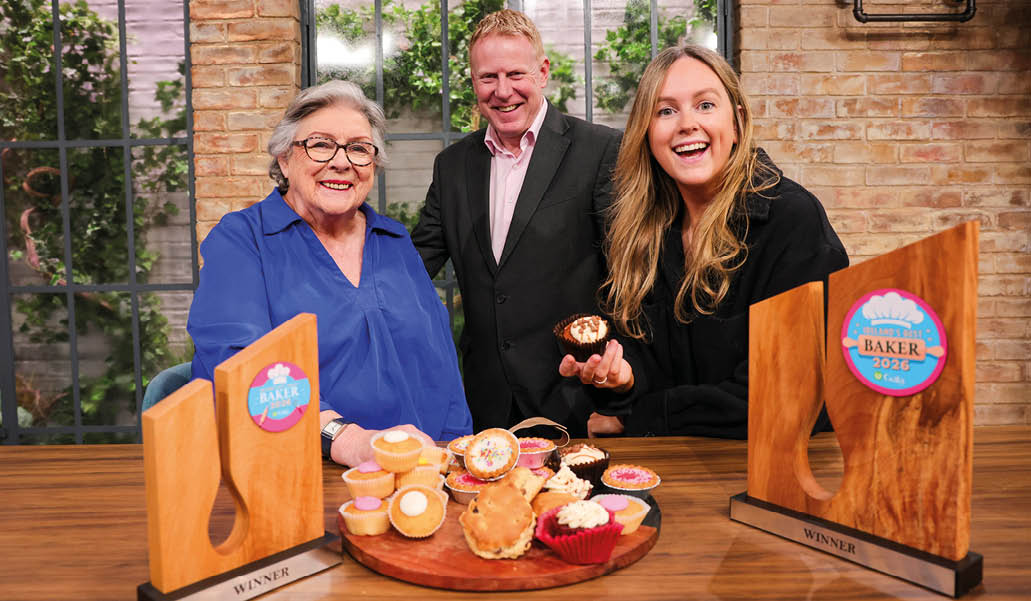 A wooden table with a tray of cupcakes. Description generated by AI