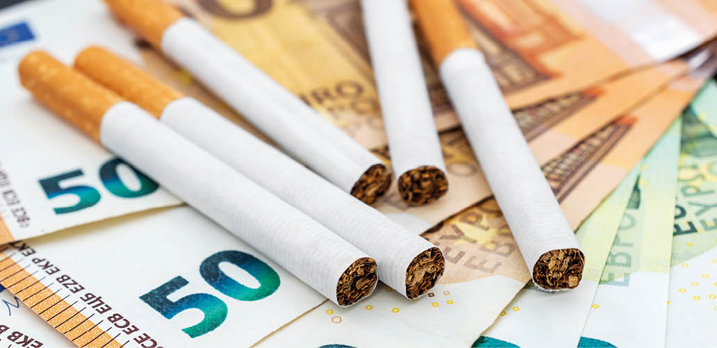 Cigarettes on the euro bills. Close up.