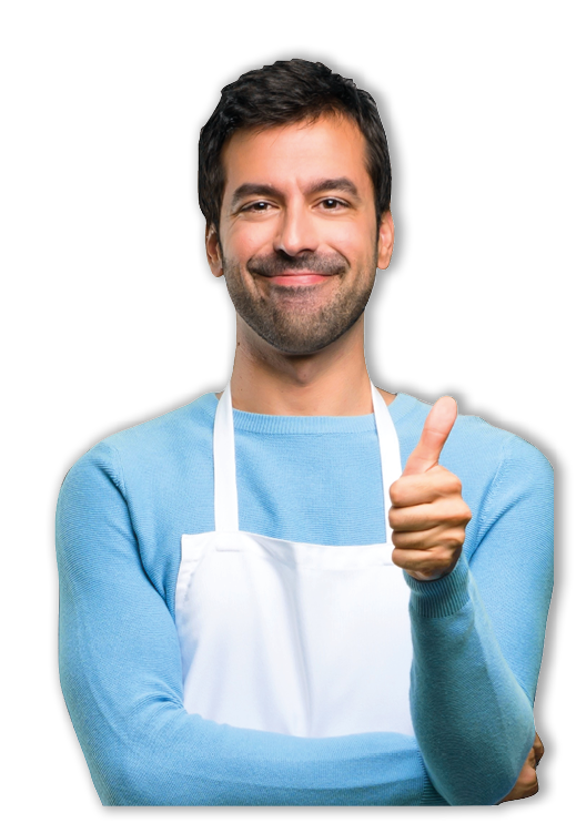Man wearing an apron giving a thumbs up gesture and smiling because something good has happened in a bakery