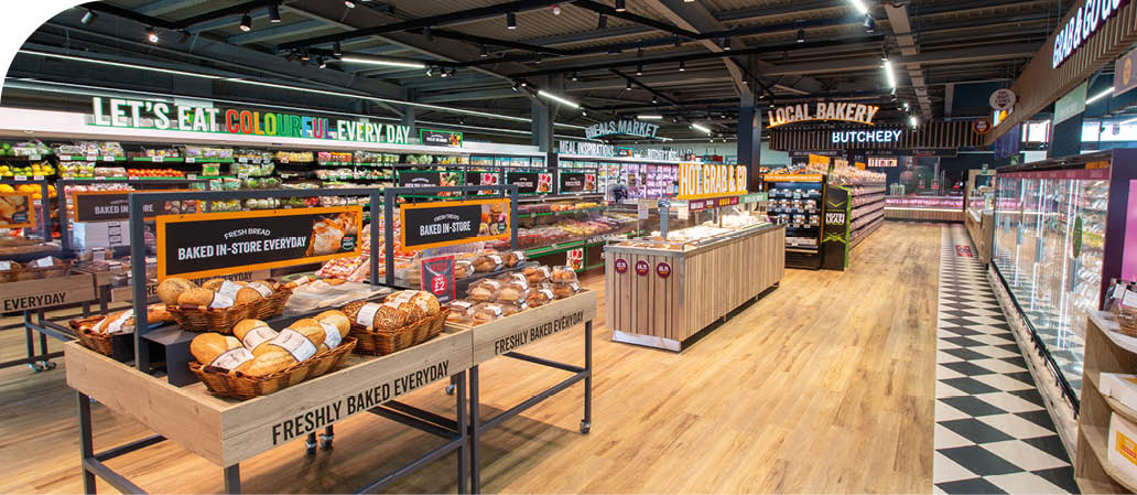 A large grocery store with a lot of food on display. Description generated by AI