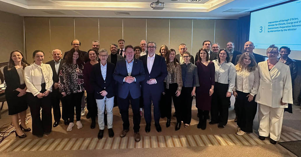 A group of people standing in front of a camera. Description generated by AI