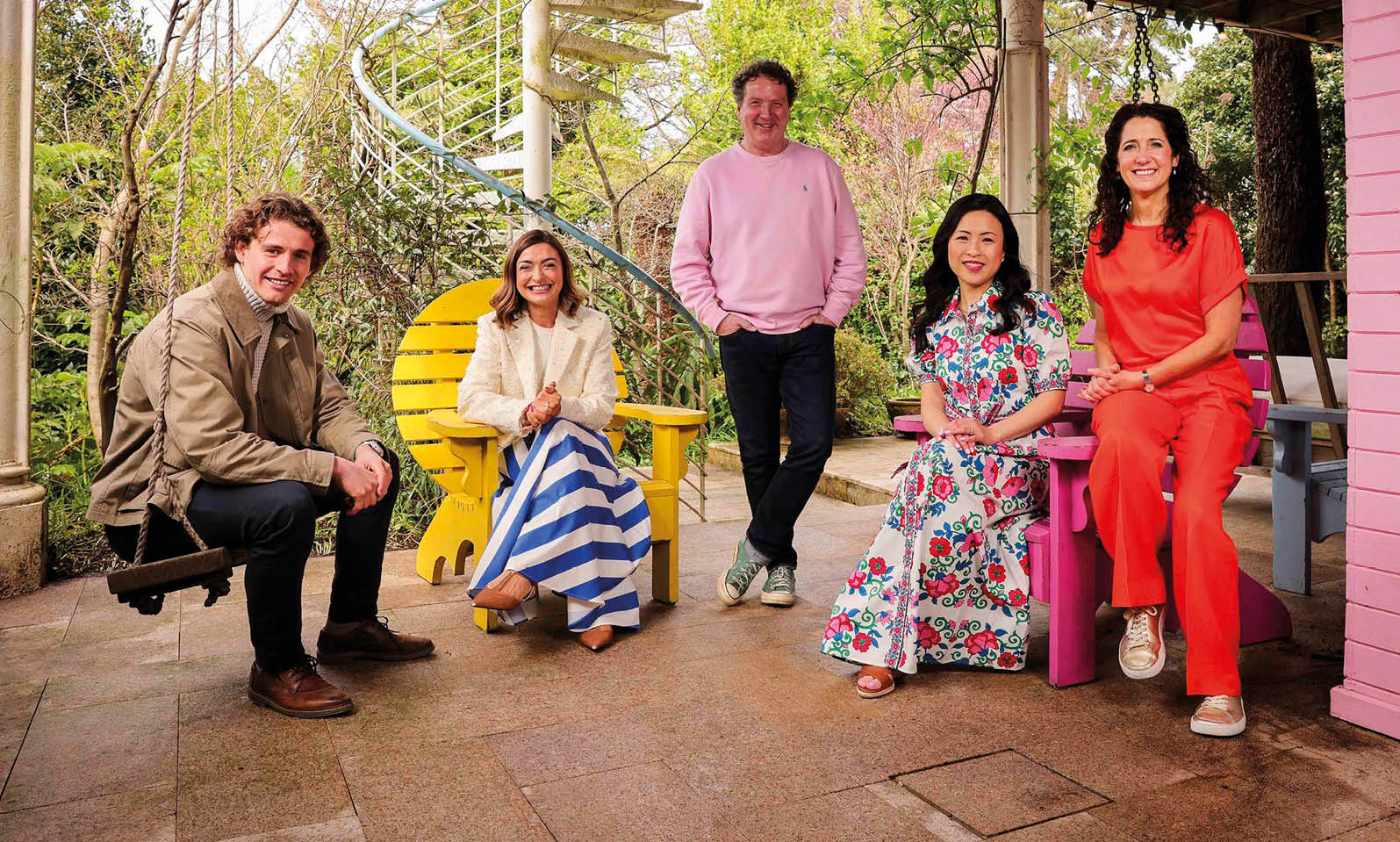 A group of people sitting on chairs outside. Description generated by AI