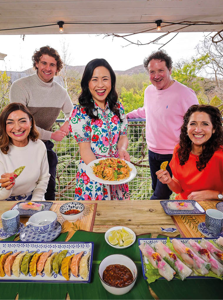 A group of people are sitting around a table with food. Description generated by AI