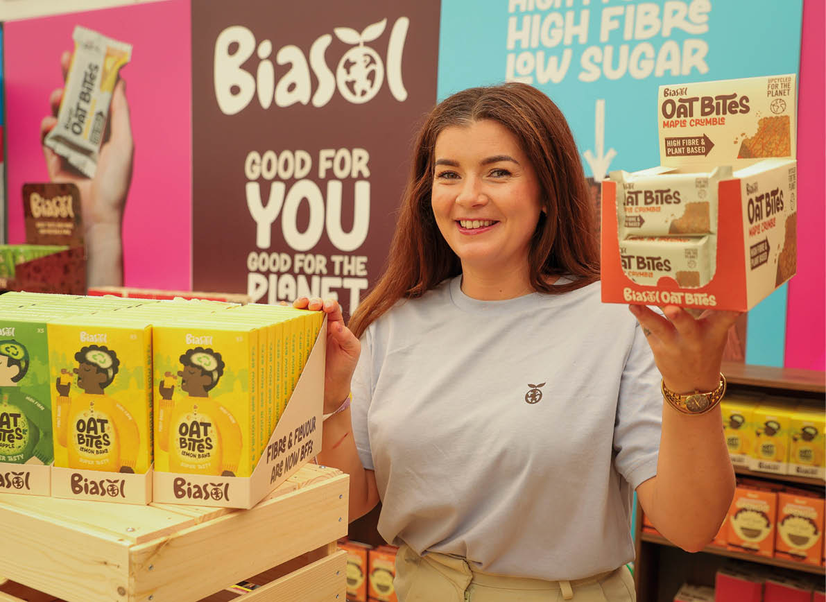 A woman holding a box of oat biscuits. Description generated by AI