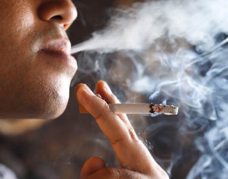 A man smoking a cigarette. Description generated by AI