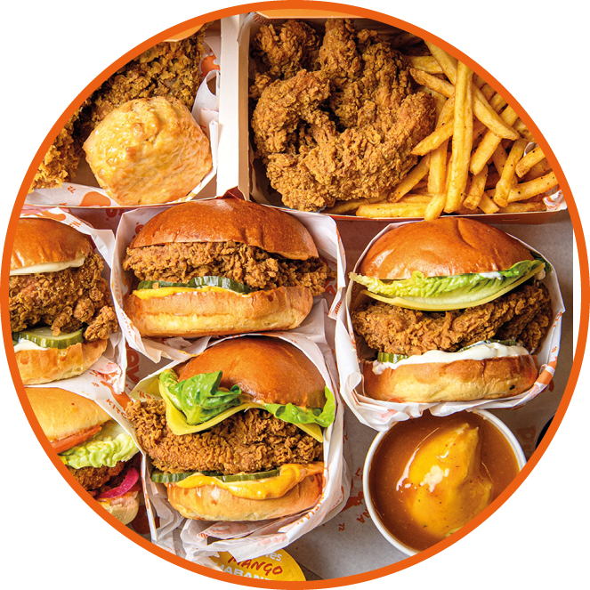 A variety of sandwiches and fries are displayed in a box. Description generated by AI
