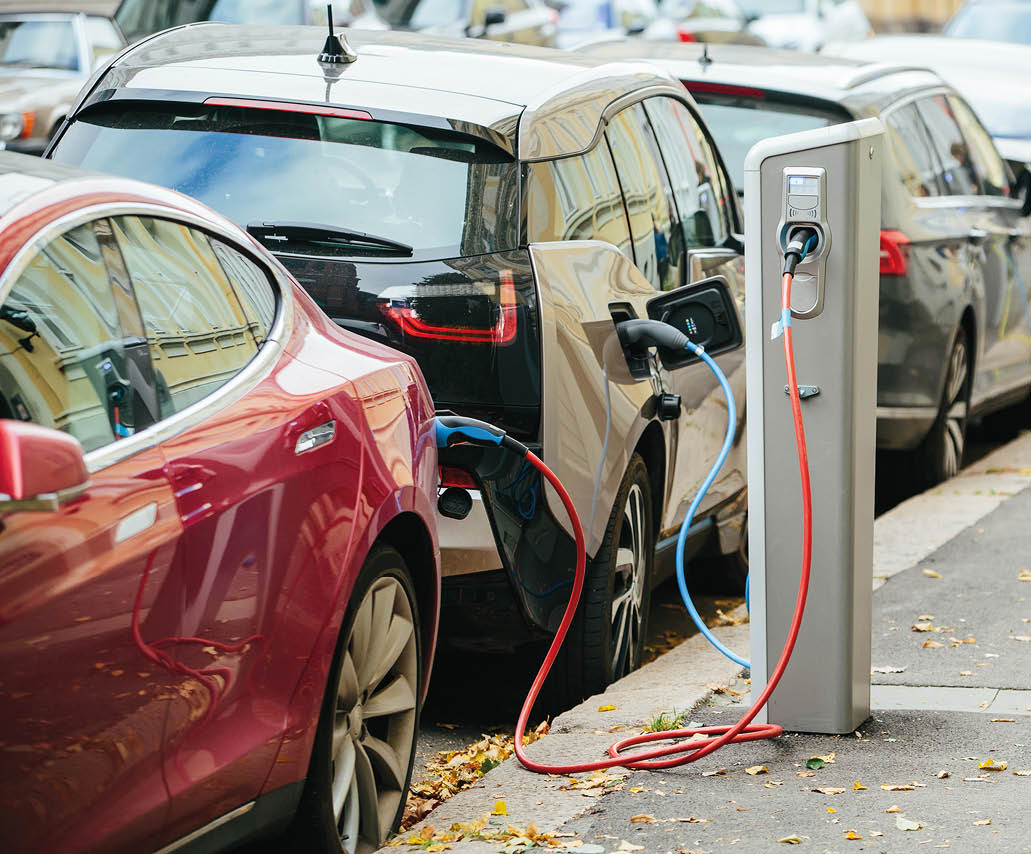Charging modern electric cars (new energy vehicles, NEV) on the street station