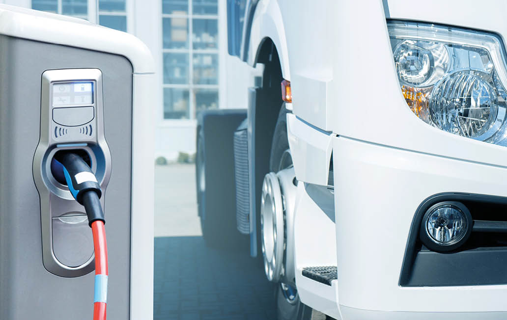 Electric vehicles charging station on a background of a truck. Concept
