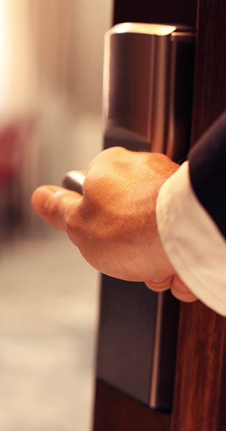 Picture showing hand of businessman opening hotel room