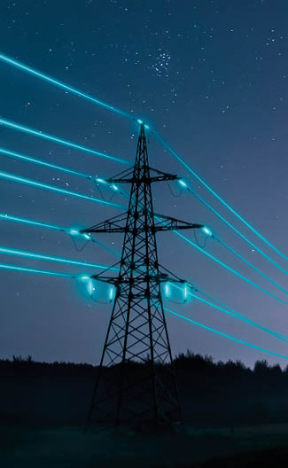 Electricity transmission towers with glowing wires against the starry sky. Energy concept.