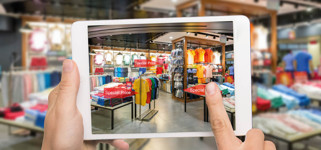 Augmented reality marketing concept. Hand holding digital tablet smart phone use AR application to check special sale price in retail fashion shop mall