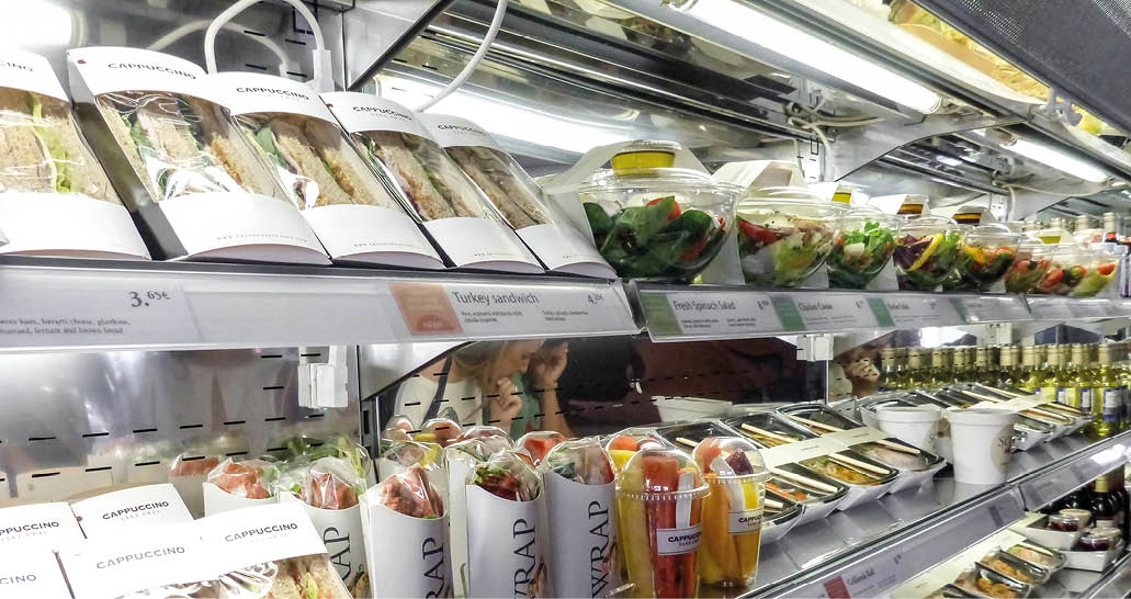 Madrid, Spain - May 10 2019 - Bad habits of the human in modern times: shelf full of pre-packaged foods, ready to eat. Plastic abuse to contain ready-to-eat salads, sandwiches, fruit and vegetables.