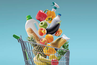 Fresh groceries and goods falling in a supermarket trolley, grocery shopping concept