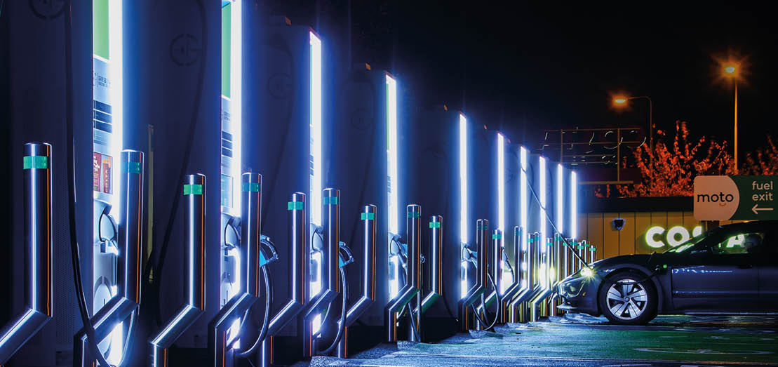 Exeter. UK. 11-11-23.E V charging point, placed on a service forecourt. Rows of energy power plugs waiting to be connected into electric cars. copy space. “Shotlisteco"