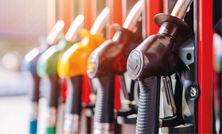 Diesel petrol fuel pistols nozzle refill at gas station. Fuel price crisis impact fuel cost in transport business and Travel energy consumption rise in petroleum gasoline station service production.