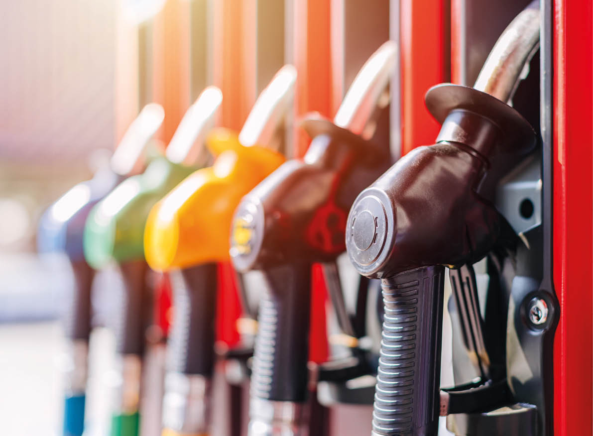 Diesel petrol fuel pistols nozzle refill at gas station. Fuel price crisis impact fuel cost in transport business and Travel energy consumption rise in petroleum gasoline station service production.