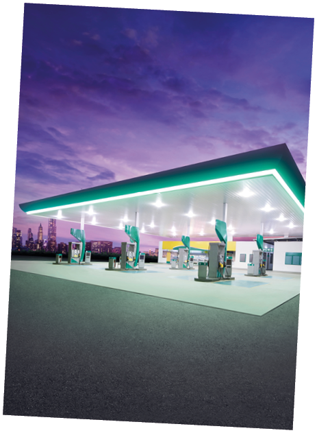 Petrol gas station at night with city building 
