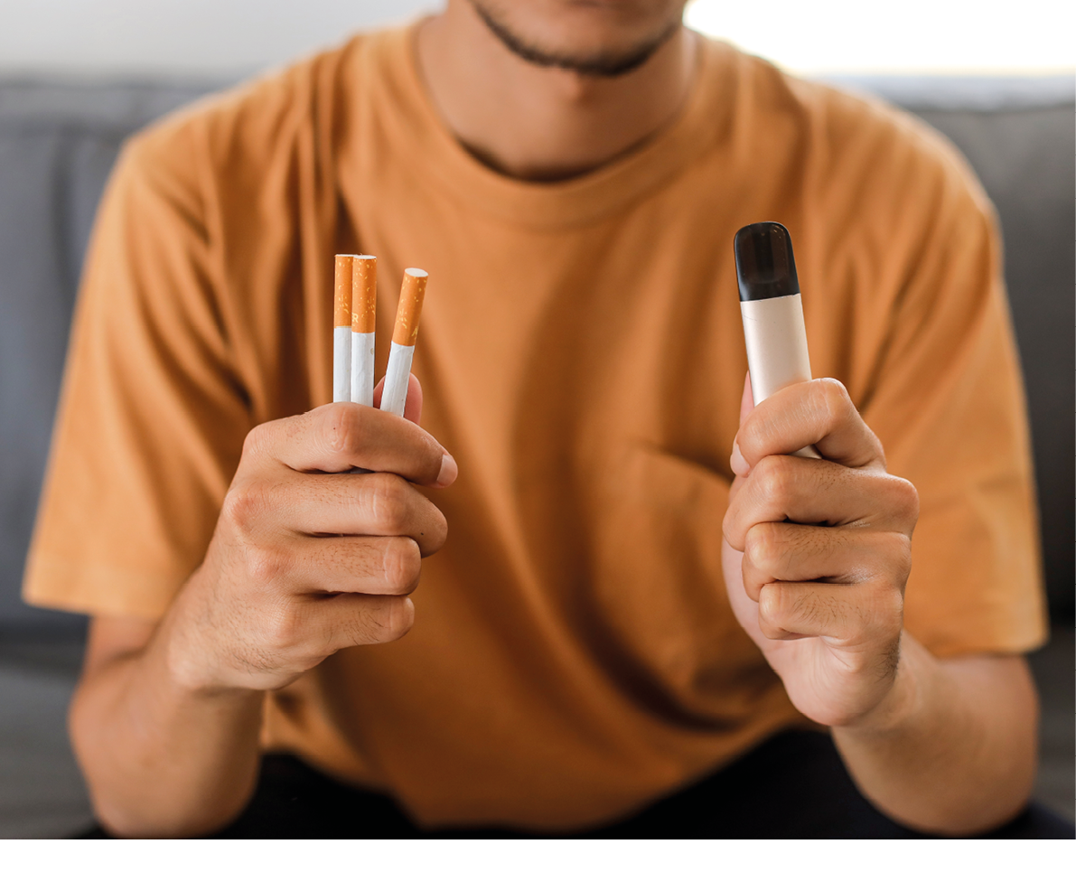 Man Holding Vape And Tobacco Cigarette