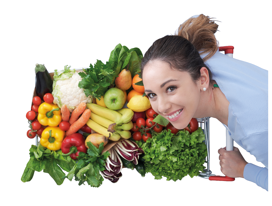 Happy young woman pushing a trolley full of delicious vegetables and fruits: fresh healthy food and grocery shopping concept
