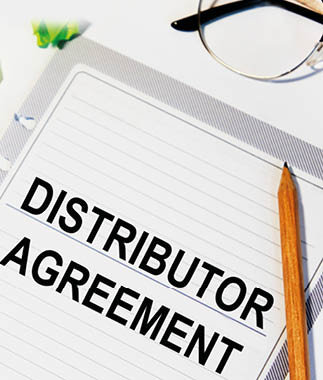 On a sheet from the diary inscription DISTRIBUTOR AGREEMENT, next to it is a pencil, glasses.