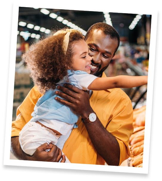 african american little child pointing by finger at pastry to father in supermarket 