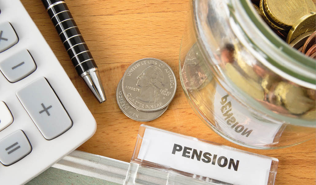 Pension file with calculator, pen, coins and glass jar