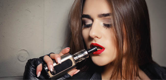 Trendy electronic gadget. Quit smoking nicotine, start vaping glycerin with fruit flavor.Quit smoking with e-cigarette quote. Smoke. Popular vaporizer device e-cig filled with e-liquid or e-juice.