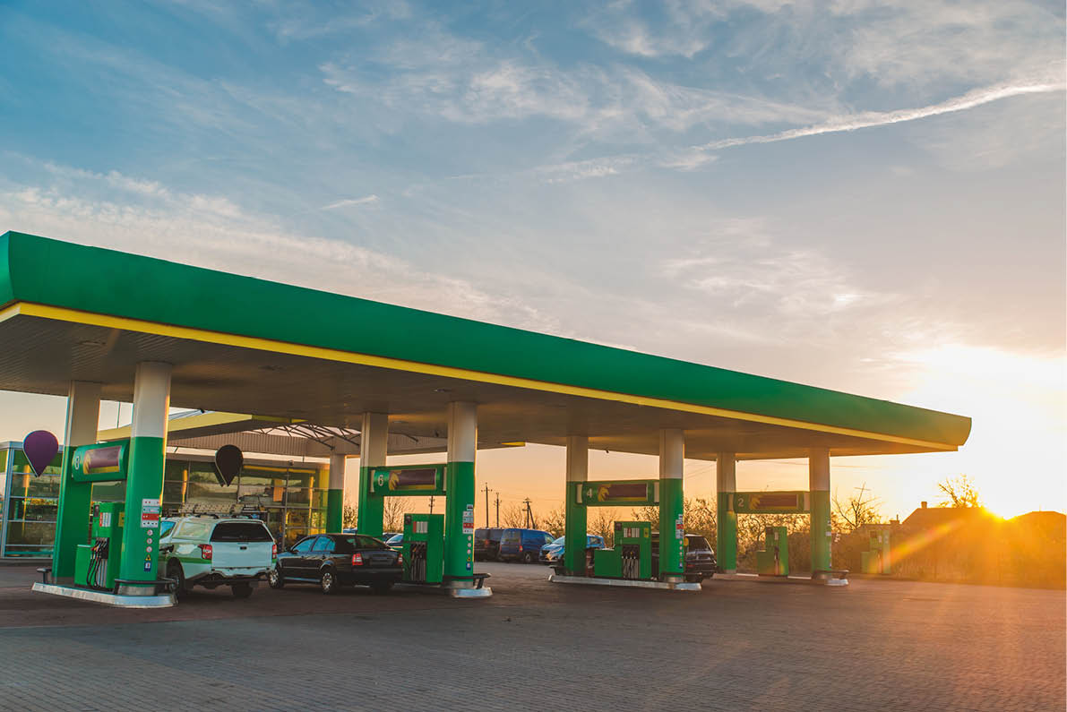 wide view of gas station on sunset copy space